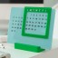 Helio Ferretti | Acrylic 365-Day Desk Calendar | Light Blue/Green
